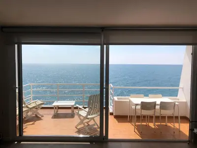 a balcony with a table and chairs on a cruise ship at Ponent - Espectaculares vistas al mar in San Pol de Mar