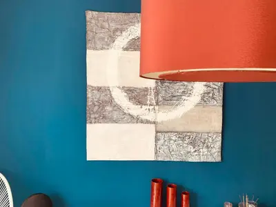a painting on a blue wall with a red lamp at Penthouse Sitges in Sitges
