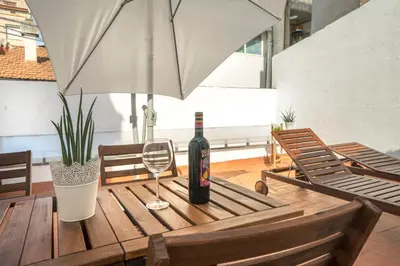 a bottle of wine sitting on a table with a glass at Hotelito Boutique Cinca in Hospitalet de Llobregat