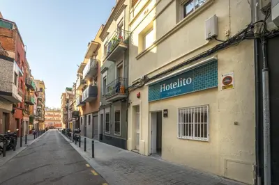 a street with a building with a sign on it at Hotelito Boutique Cinca in Hospitalet de Llobregat
