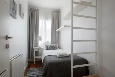 a bedroom with a bed and a book shelf at Tendency Rambla del Poblenou in Barcelona