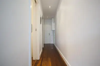 an empty hallway with white walls and wooden floors at Tendency Rambla del Poblenou in Barcelona