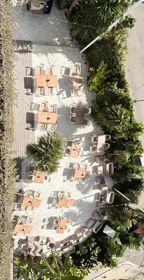 a store front of a building with tables and chairs at Hotel Sitges in Sitges