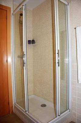 a shower with a glass door in a bathroom at Villa Sitges La Calma 10 minutes drive Sitges 2 minutes walk Garraf Park AC in Sant Pere de Ribes