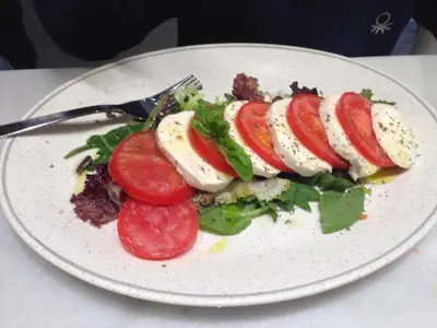 a plate of food with vegetables and eggs on it at Alguera Apartments Napols in Barcelona