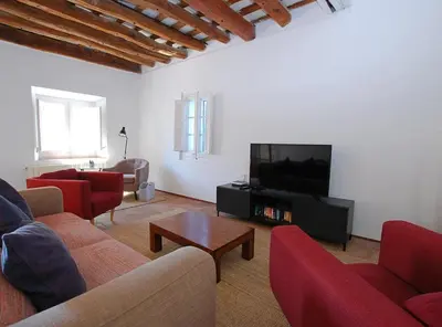 a living room with couches and a flat screen tv at The Painter's Home in Vilassar de Mar