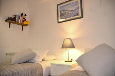 a bedroom with two beds and a lamp on a table at ARTS HOUSE - Cabrils, Maresme, Barcelona in Cabrils