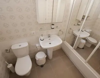 a bathroom with a toilet and a sink and a mirror at Apartamento Maraka Playa Castelldefels in Castelldefels