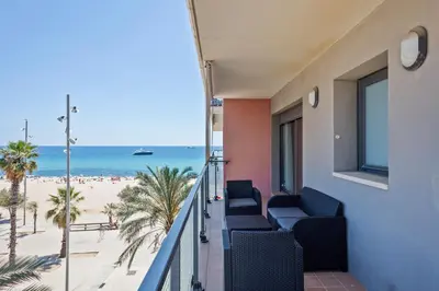 a balcony with chairs and a view of the beach at Alcam Badalona Playa Norte in Badalona