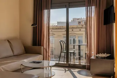 a living room with a table and a couch at Barcelona Apartment Gran de Gràcia in Barcelona