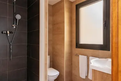 three bunk beds in a room with a window at Barcelona Apartment Gran de Gràcia in Barcelona