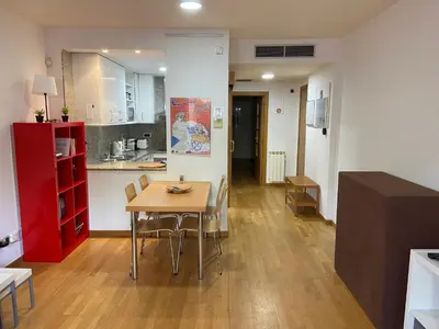 a kitchen and dining room with a table and chairs at Apartamentos City Beach in Barcelona