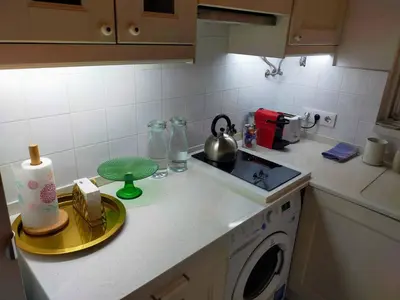a kitchen counter with a sink and a washing machine at Barceloneta Port Ramblas in Barcelona