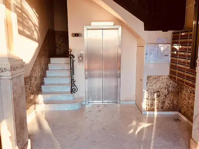 a hallway with stairs and a door in a building at Barceloneta Port Ramblas in Barcelona