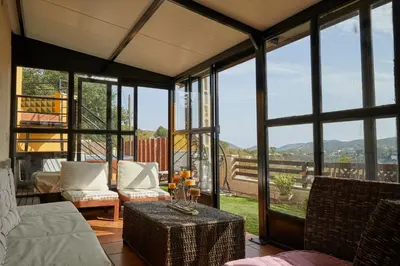 a living room with a couch and a table at Amazing Vila close to Sitges, jacuzzi, swimming pool & exellent views in Olivella