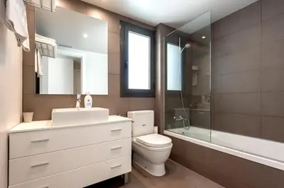 a bathroom with a toilet and a sink and a shower at Espais Blaus Apartments in Barcelona