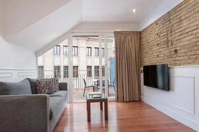 a living room with a couch and a tv at Enjoybcn Dali Apartments in Barcelona