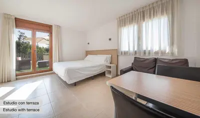 a hotel room with a bed and a table and chairs at Sono & SPA - Adults Only in La Garriga
