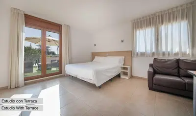 a bedroom with a bed and a couch and a window at Sono & SPA - Adults Only in La Garriga
