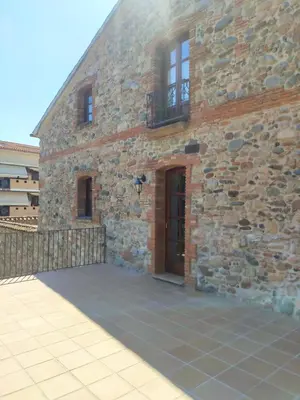 a kitchen with white cabinets and a sink at Mas Can Calet Aparthotel in Les Franqueses del Vallès