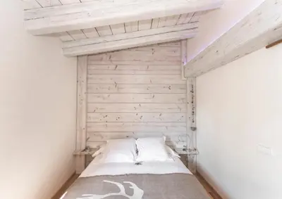 a bed in a room with a wooden ceiling at Can Caponet in Lliçà d'Amunt