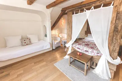 a living room with a bed and a table at Can Caponet in Lliçà d'Amunt