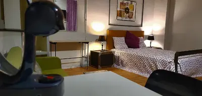 a small bedroom with a bed and a table at Great Sleep Loft in Barcelona
