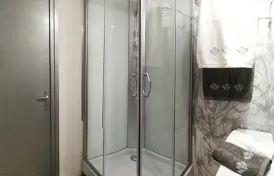 a shower with a glass door in a bathroom at Great Sleep Loft in Barcelona