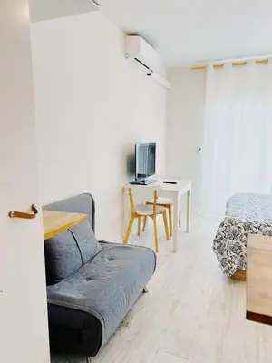 a living room with a couch and a table at Tropical Apartaments Euroviajeros in Pineda de Mar