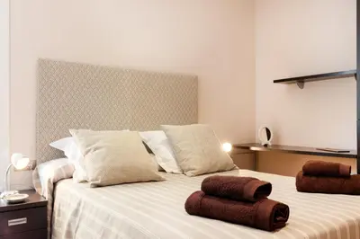 a bedroom with a bed with two towels on it at Dream Gracia Apartments in Barcelona