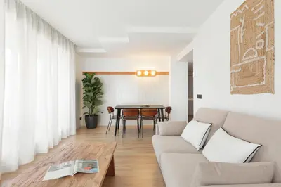 a living room with a couch and a table at Port Forum Apartments by Olala Homes in Sant Adria de Besos