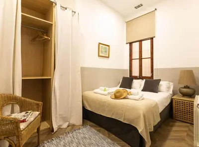 a bedroom with a bed with a hat on it at GREAT SPACIOUS APARTMENT IN THE GOTHIC QUARTER in Barcelona