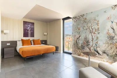 a bedroom with a bed and a large painting on the wall at Cosmo Suite Penthouse in Barcelona