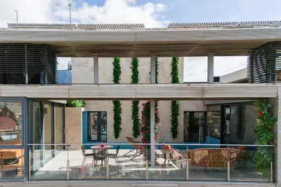 a house with a balcony with a table and chairs at Cosmo Suite Penthouse in Barcelona