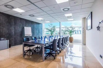 a conference room with a long table and chairs at Sleep&Fly in El Prat de Llobregat