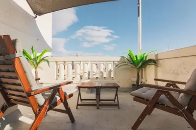 a balcony with a table and chairs on a building at Penthouse City Center With 2 Terraces And Views in Barcelona