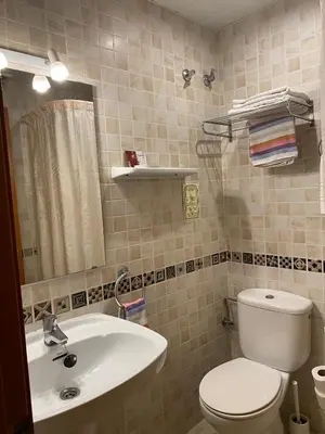 a bathroom with a sink and a mirror at Pensión Coral in Barcelona
