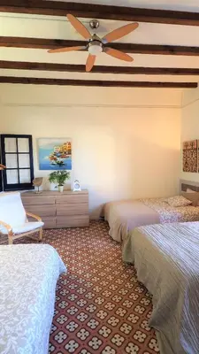 a bedroom with two beds and a ceiling fan at MARISOL SEAVIEW & BEACH - apartment in Masnou