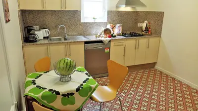 a kitchen with a table and a table and chairs at MARISOL SEAVIEW & BEACH - apartment in Masnou