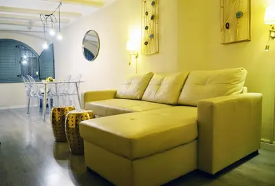 a living room with a couch and a table at Barcelona Mercaders Apartments in Barcelona
