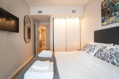 a bedroom with a bed with two towels on it at Tendency Apartments Forum in Sant Adria de Besos