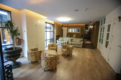 a living room with a couch and a table and chairs at Gatell Hotel in Vilanova i la Geltrú