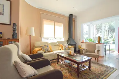 a living room with a couch and a table at VILLA BELLA ESTANÇA in Castelldefels