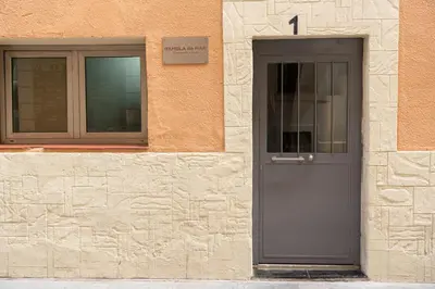 a building with a gray door and a window at Rambla de Mar Apartments in Barcelona