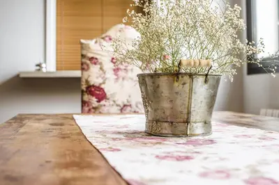 a bucket of flowers sitting on a table at Anita's Bed and Breakfast in Barcelona
