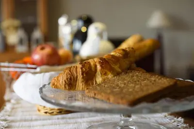 a glass plate with a piece of bread on a table at Anita's Bed and Breakfast in Barcelona