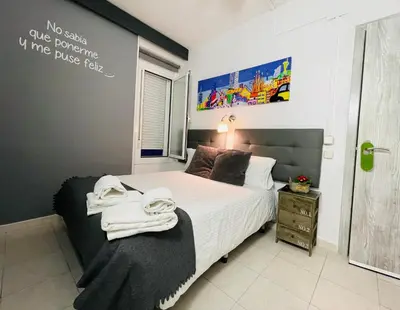 a bedroom with a bed with towels on it at Hostal Lleida in Barcelona