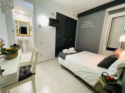 a small bedroom with a bed and a bathroom at Hostal Lleida in Barcelona