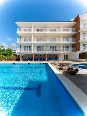a swimming pool in front of a building at Apartamentos Sunway Arizona in Sitges