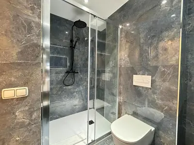 a bathroom with a shower and a toilet at BarcelonaForRent Sant Pau Suite in Barcelona